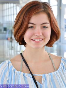 Cute redhead strips naked outdoors to spread pussy wide in the sunshine